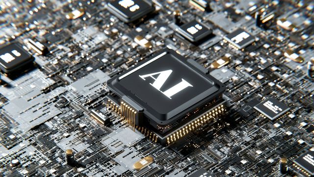 The letters AI emblazoned on a computer chip. 