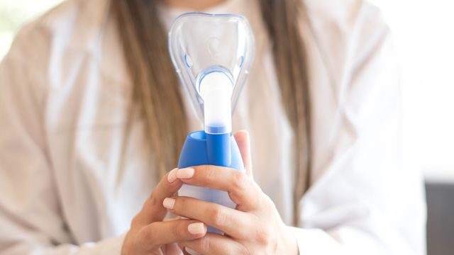 Woman holding a nebuliser. 