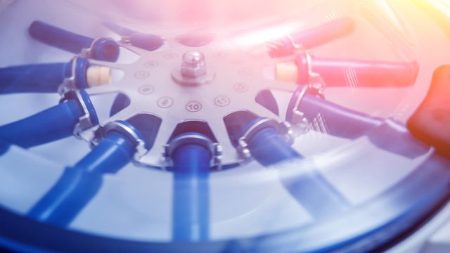 A closeup of blue tubes in a centrifuge 