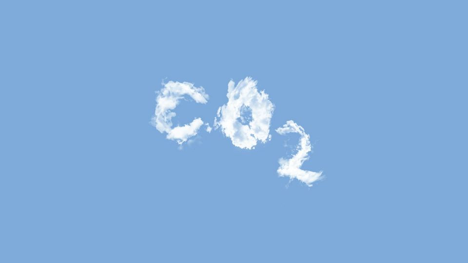 White fluffy clouds form the letters CO2 on a blue sky.