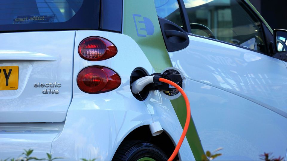 An electric car, plugged in to charge.