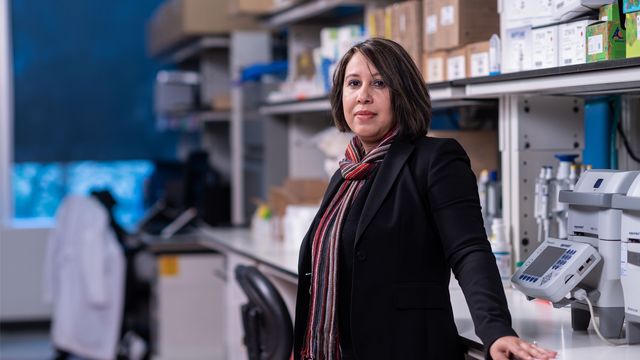 Dr. Sangeeta Goswami stands at a lab bench, 